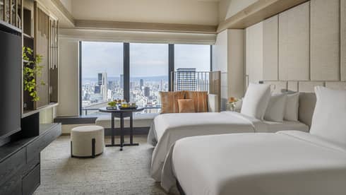 Hotel room with two single beds and Osaka city view