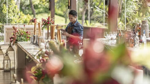 Bartender mixes drink at outdoor bar