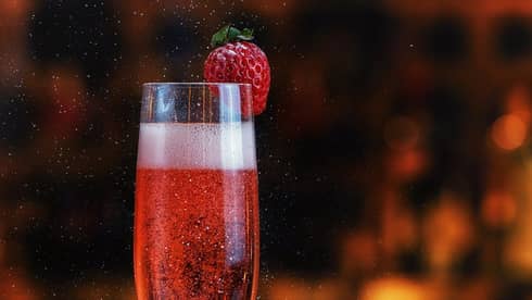 Christmas cocktail with berry on the rim