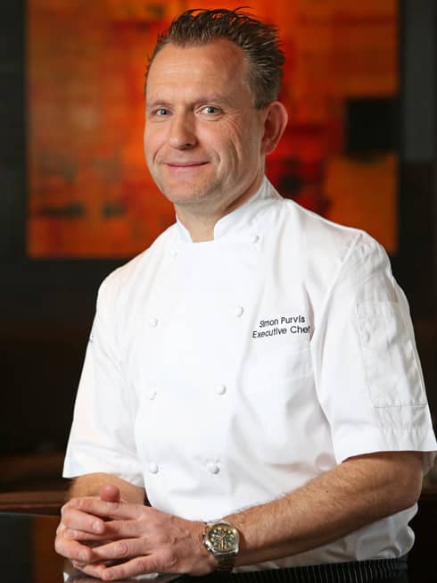 Portrait photo of Executive Chef Simon Purvis in white uniform