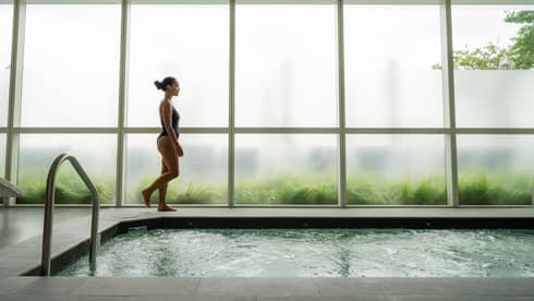 Woman walking next to the pool