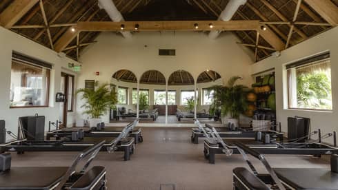 Fitness room with pilates equipment set up for a class
