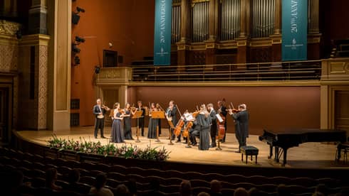 Musician ensemble standing on grand stage