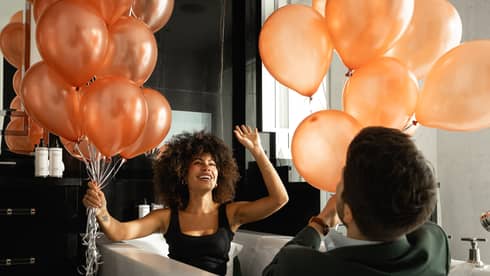 Man and woman playing with balloons