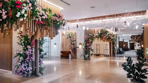Each corner of the room is covered in bouquets of red, pink and white flowers.