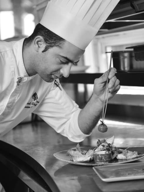 Chef from Four Seasons Hotel Doha puts final touches on a dish before sending it out