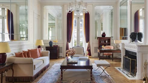 Elegant hotel Royal Suite living room, with crystal chandelier, sofa and fireplace