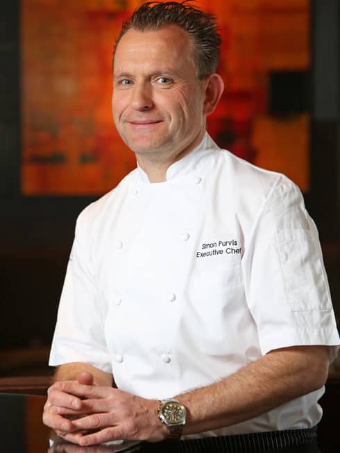 Portrait photo of Executive Chef Simon Purvis in white uniform