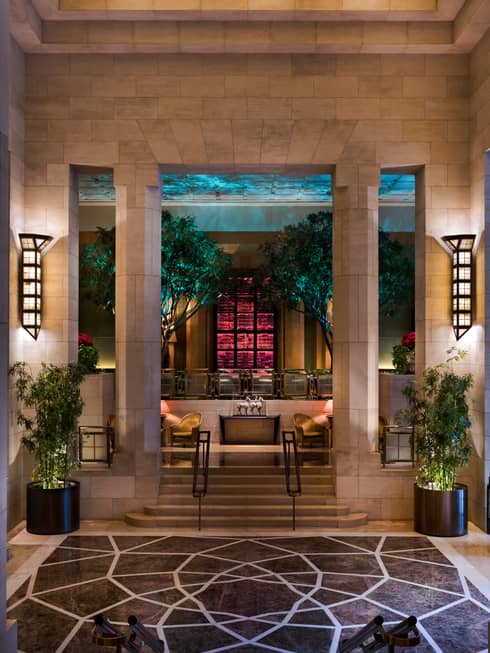 Lanterns on stone pillars, stairs leading up to The Garden bar and lounge 