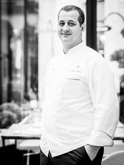 Black and white portrait photo of Chef Alan Taudon in uniform