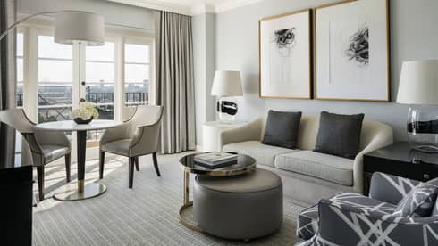 Hollywood Suite grey sofa, armchair, coffee table by cafe table, large window