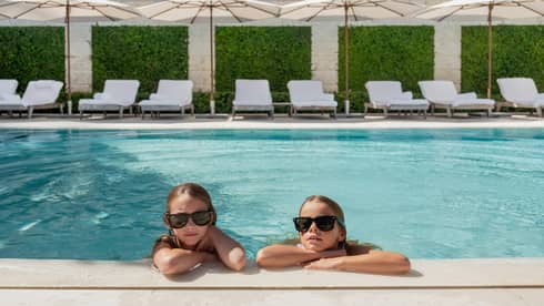 Two young girls in luxury hotel pool