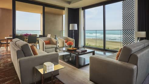 Imperial Suite Ocean View living room sofas, armchairs, corner windows with view of beach, Atlantic