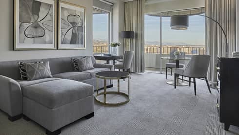Living room with floor-to-ceiling windows in a Luxury Suite