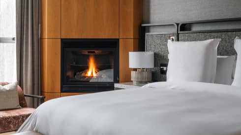 Guest room bed and fireplace