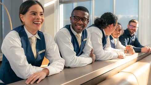 A group of team members leaning on a counter.