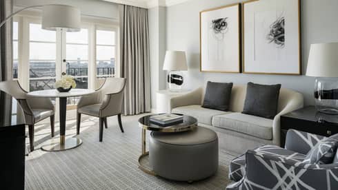 Hollywood Suite grey sofa, armchair, coffee table by cafe table, large window