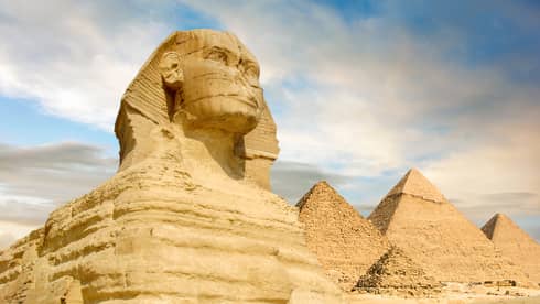 The Sphinx and the great pyramids under interesting evening clouds, Cairo, Egypt