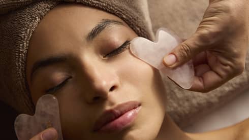 A person receives a facial treatment.