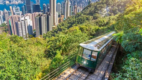 The Peak Tram rises about Hong Kong city on a lush mountainside