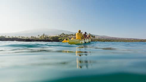 A group of guests take a canoe out on the water