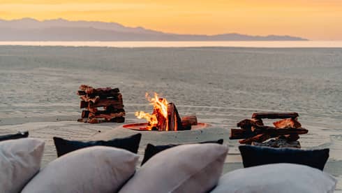 A bonfire on the beach at sunset