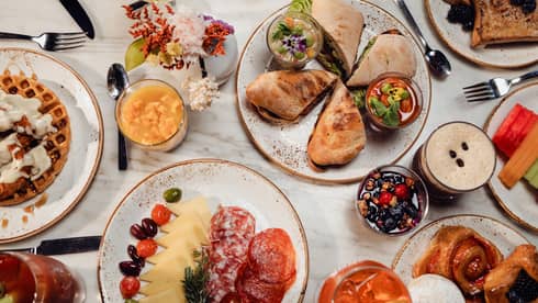 Breakfast dishes included charcuterie, waffles and french toast on a table