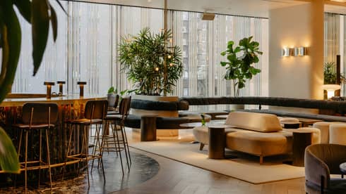 Hotel lounge with modern seating and floor-to-ceiling windows