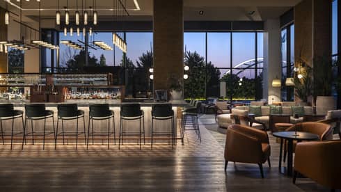 A dimly lit bar with large windows.