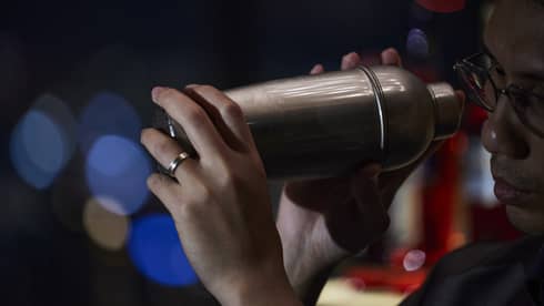 Bartender holds a cocktail shaker