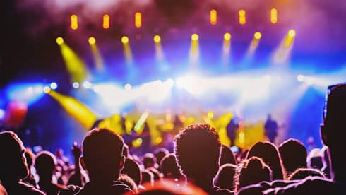A concert crowd with bright lights.