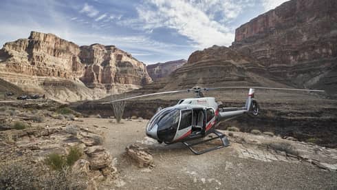 Helicopter sits on rock ledge at Grand Canyon
