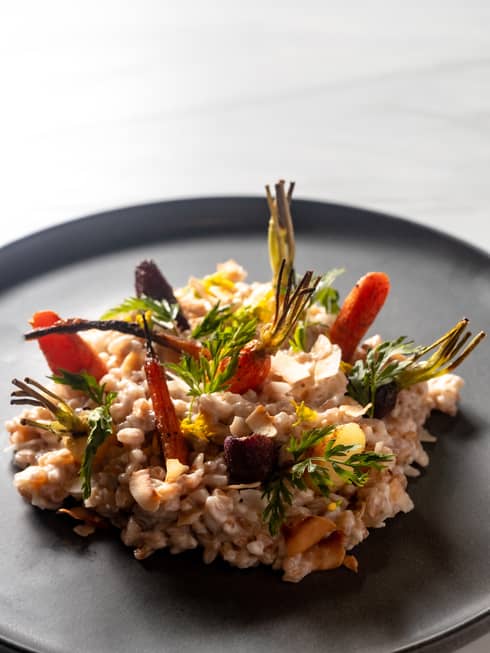Colourful food on a dark plate.