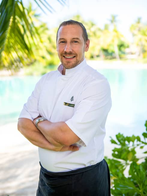 Chef Eric Desbordes in front of a beach