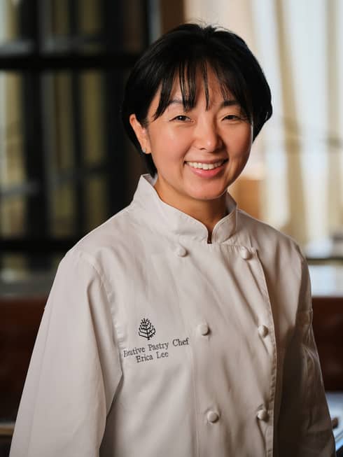 A smiling Pastry Chef Erica Lee dressed in white chef?s coat with the Four Seasons logo