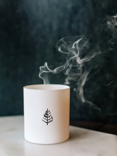 White candle with Four Seasons tree logo