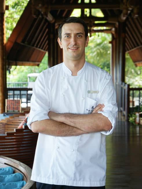 A portrait of Chef Fabian, crossing his arms over his chef shirt