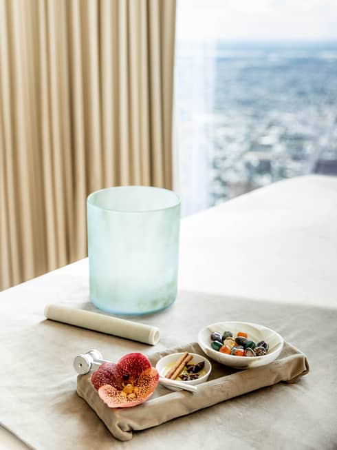 A crystal bowl and spices next to a large window.