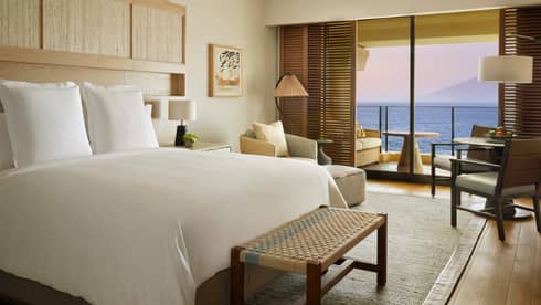 Contemporary resort room with king bed and ocean-view balcony