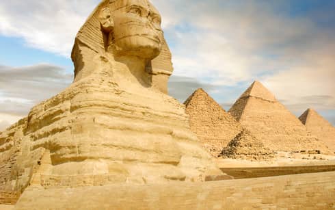 Famouse Sphinx and the great pyramids under interesting evening clouds, Cairo, Egypt