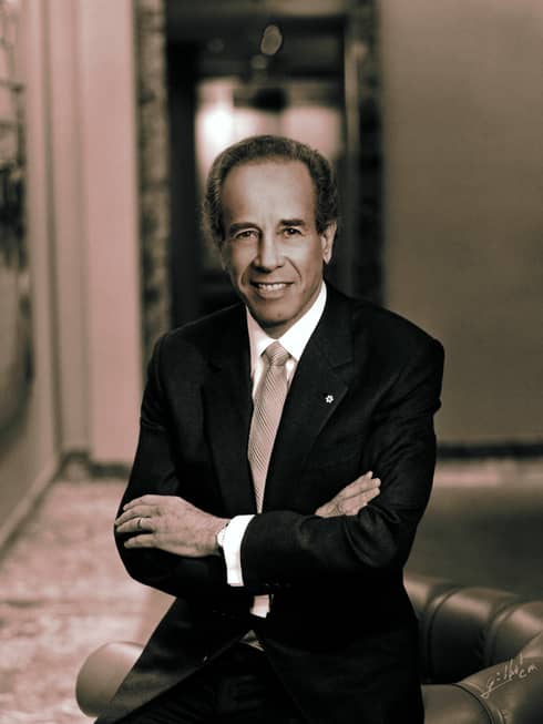 Portrait photo of Four Seasons Hotel Founder and Chairman Isador Sharp wearing suit, tie