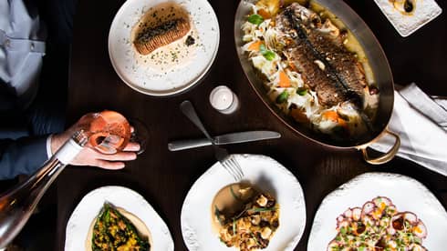 An assortment seafood on white plates.