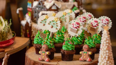 Various Christmas confections lined up on a log