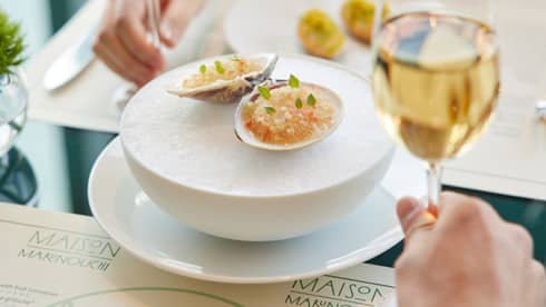 Couple enjoys oysters on the half shell and champagne at Maison Marunouchi