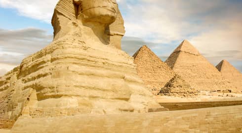 Famouse Sphinx and the great pyramids under interesting evening clouds, Cairo, Egypt