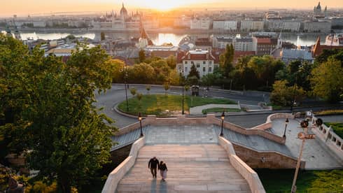 View of the city at sunset from atop steps of the hotel