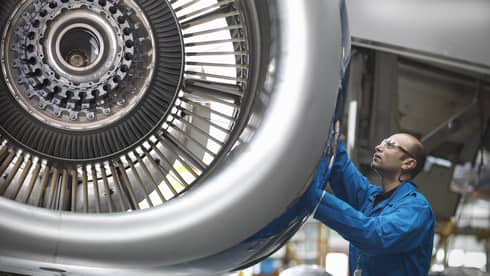 Man works on an airplane jet