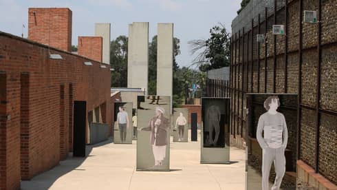 Mirrors with people on the in a small street.