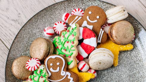 A plate of holiday sugar cookies – christmas trees and ginger bread men and candy canes