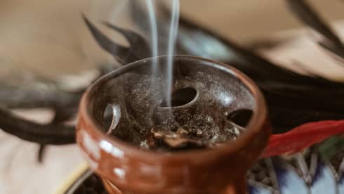 Incense burning in a small brown bowl.